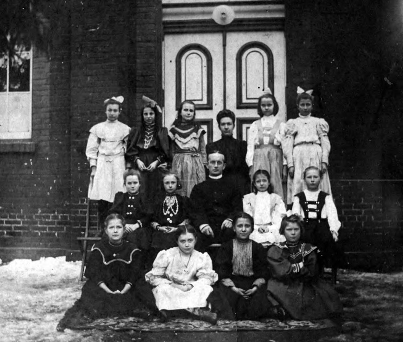 Egg Harbor City - A group of girls accompanied by the pastor and an unidentified woman outside of Zion Lutheran Church on a wintry day - late 19th or very eary 20th century